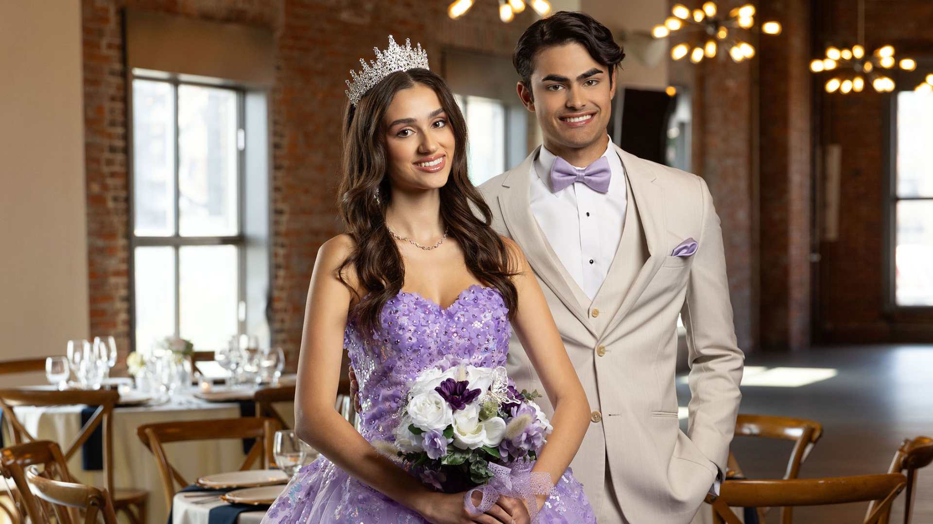 Two teenagers smiling and posing for a photo at a quinceañera celebration.