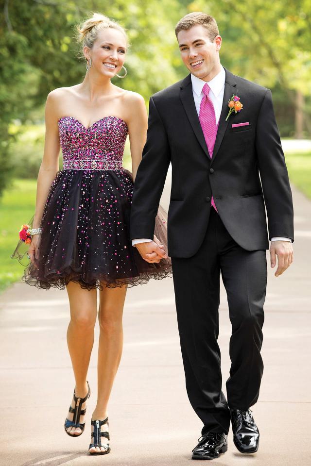 A prom couple walking in the park in the Black Michael Kors Berkeley Prom Tuxedo 