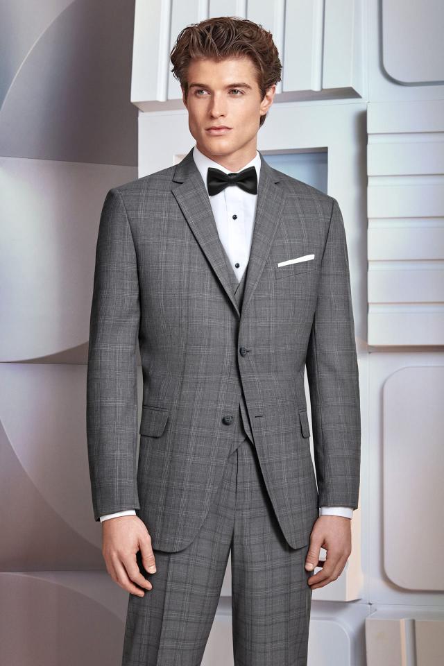 standing in a Wedding Suit Grey Plaid Ike Behar Hamilton with matching Fullback Vest and Black Bow Tie