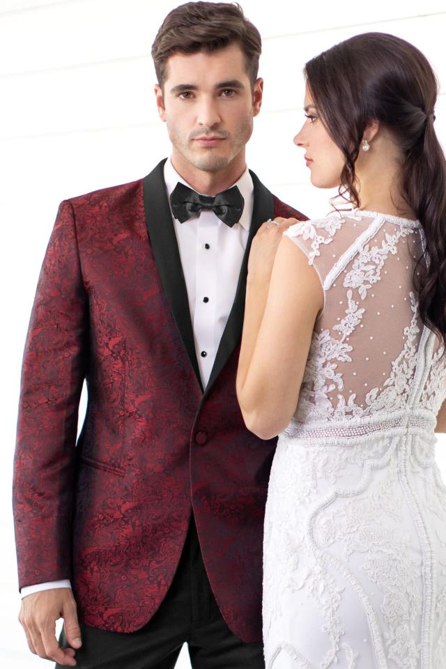 Man standing next to his bride in a Wedding Tuxedo Apple Red Paisley Mark of Distinction Aries